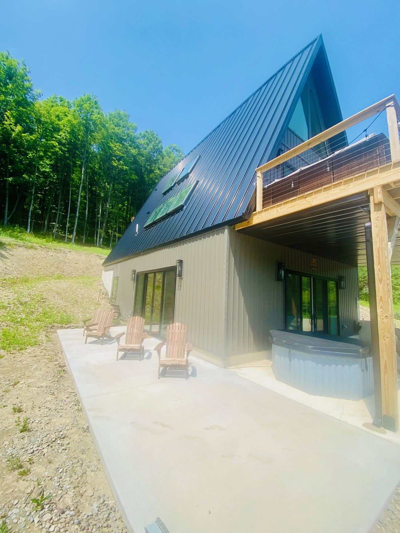 Reflection Ridge — A-frame exterior with patio and hot tub
